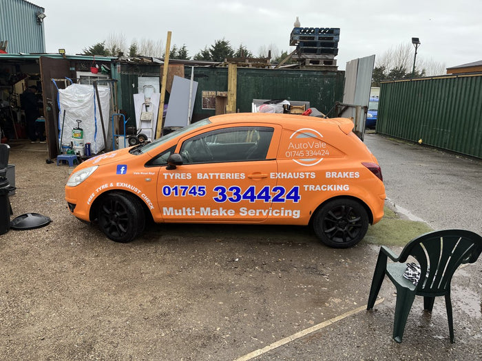 Orange garage van with lettering down the side