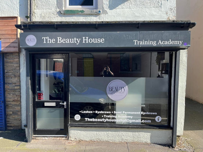 Beauty salon window with frosting, logo and lettering