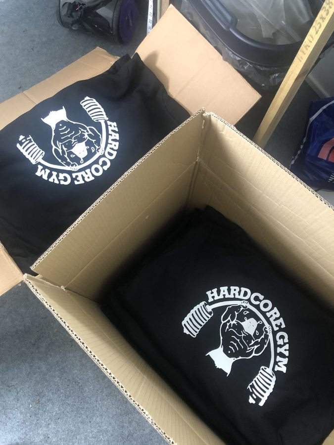 Boxes of printed black gym hoodies ready to go out